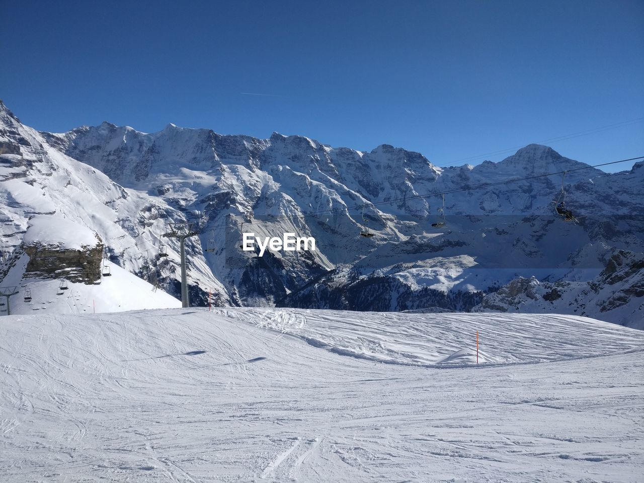Scenic view of snowcapped mountains against clear sky