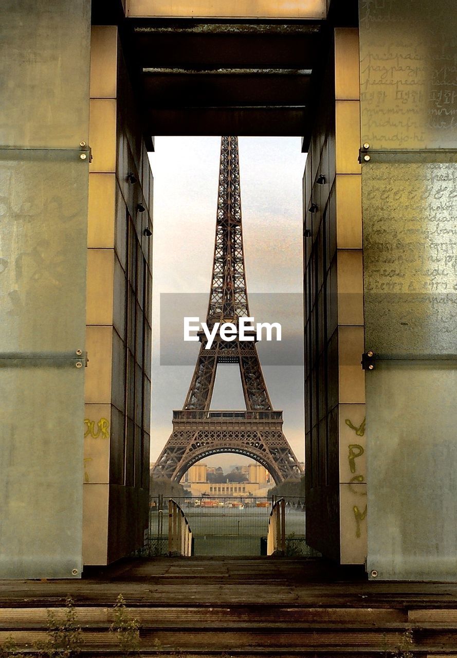  eiffel tower seen through the wall of peace located on place joffre paris 75007