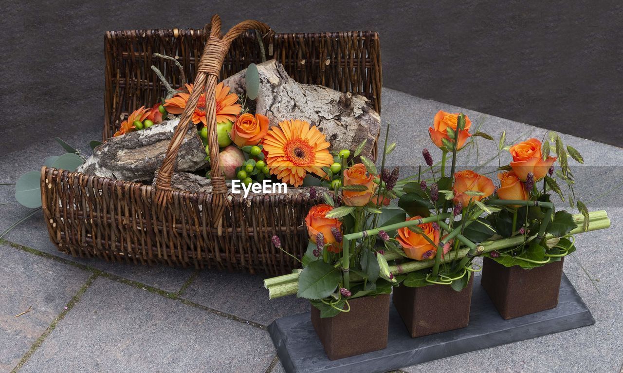 HIGH ANGLE VIEW OF ORANGE FLOWER ON TABLE