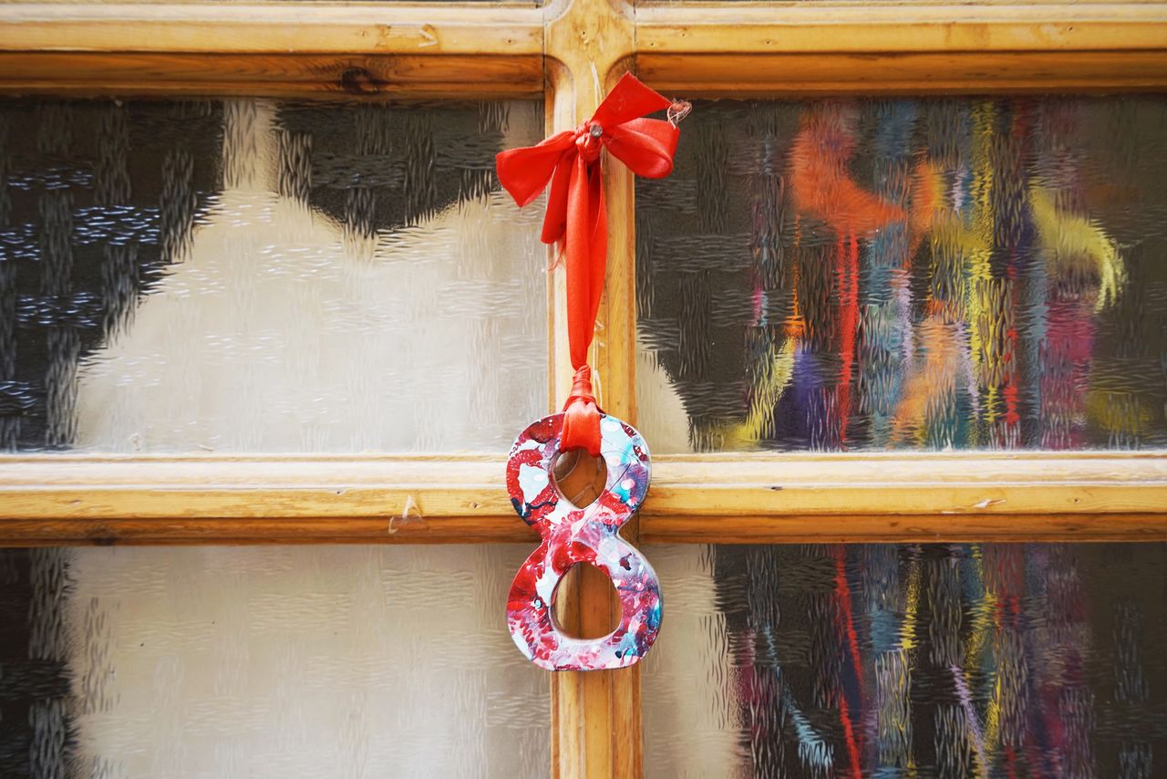 CLOSE-UP OF DECORATION HANGING ON RAILING