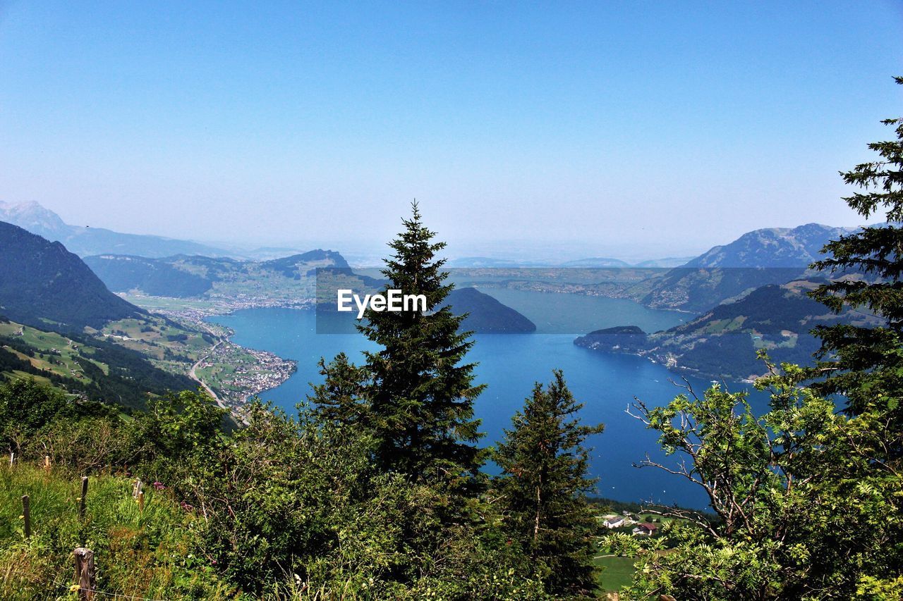Idyllic shot of lake by mountains against clear sky