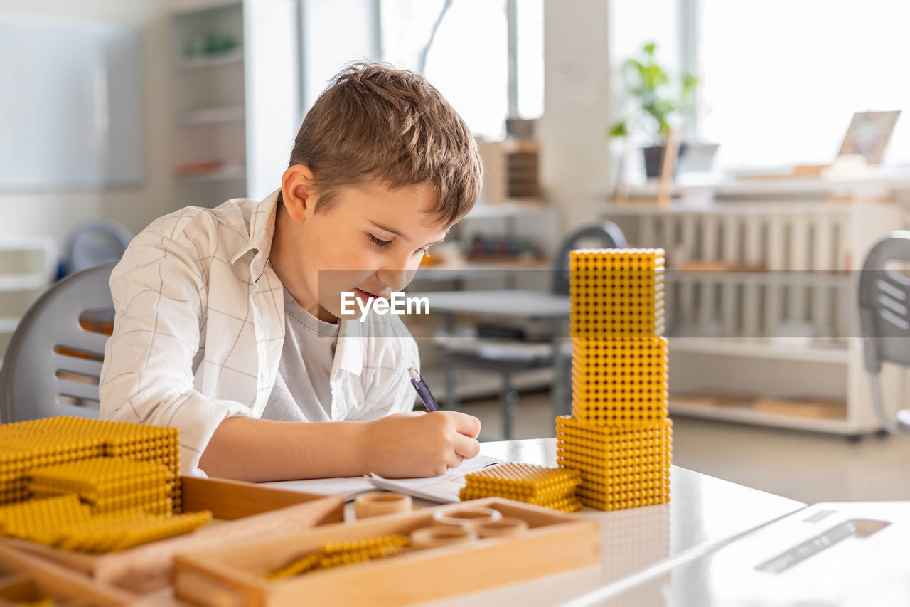 side view of young man working on table