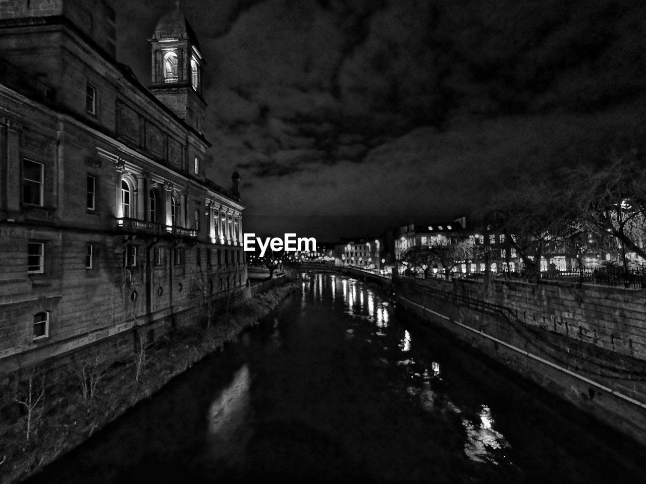 River cart amidst illuminated buildings in paisley town at night