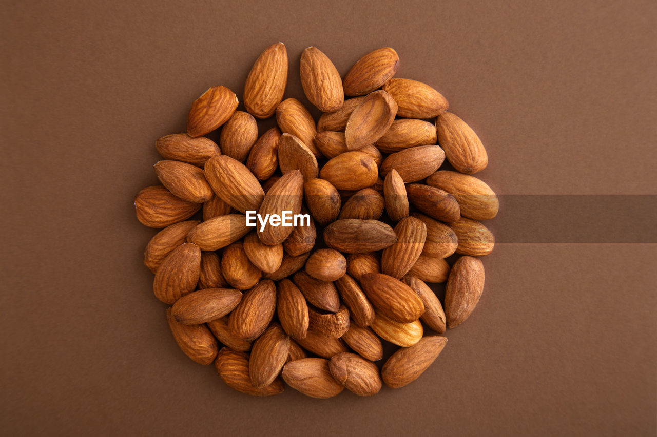 Directly above shot of almonds on brown background