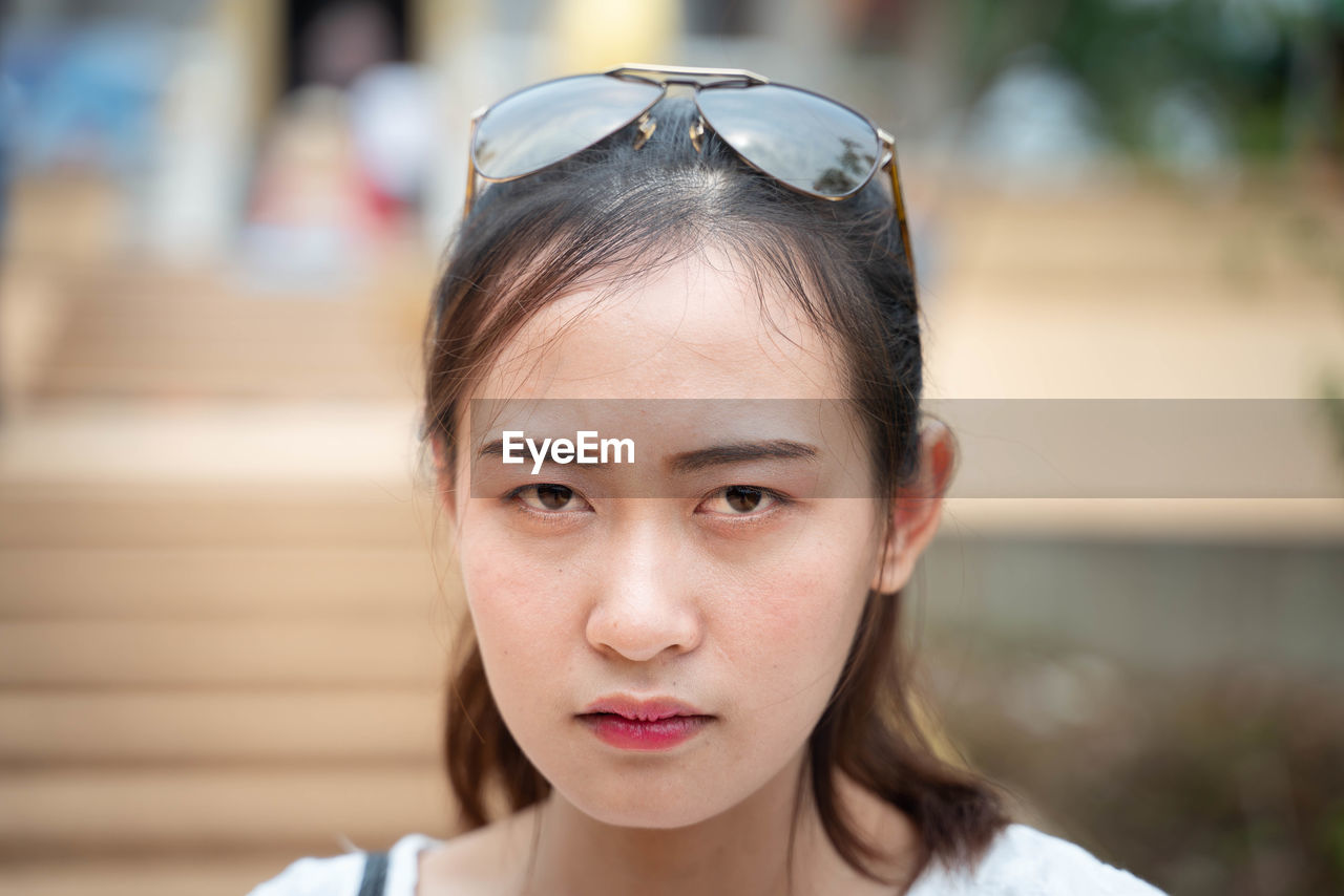 Close-up portrait of serious woman with sunglasses