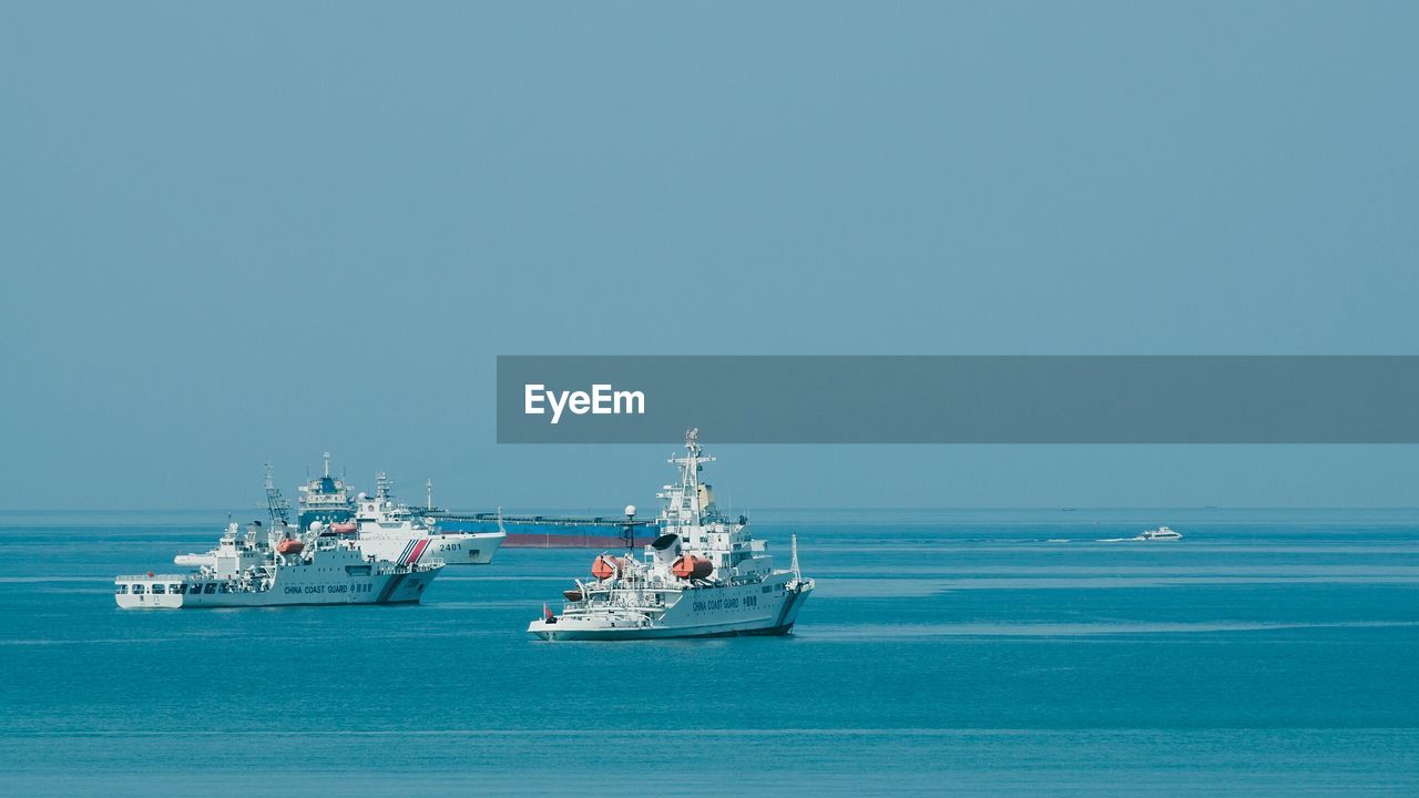 BOATS SAILING IN SEA