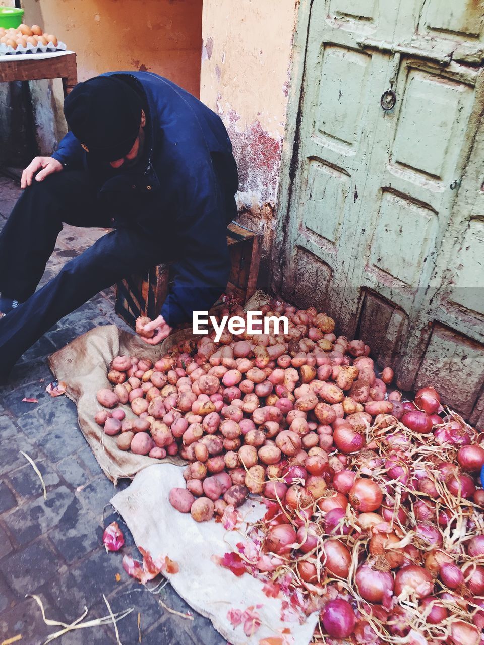 Man selling vegetables in street market