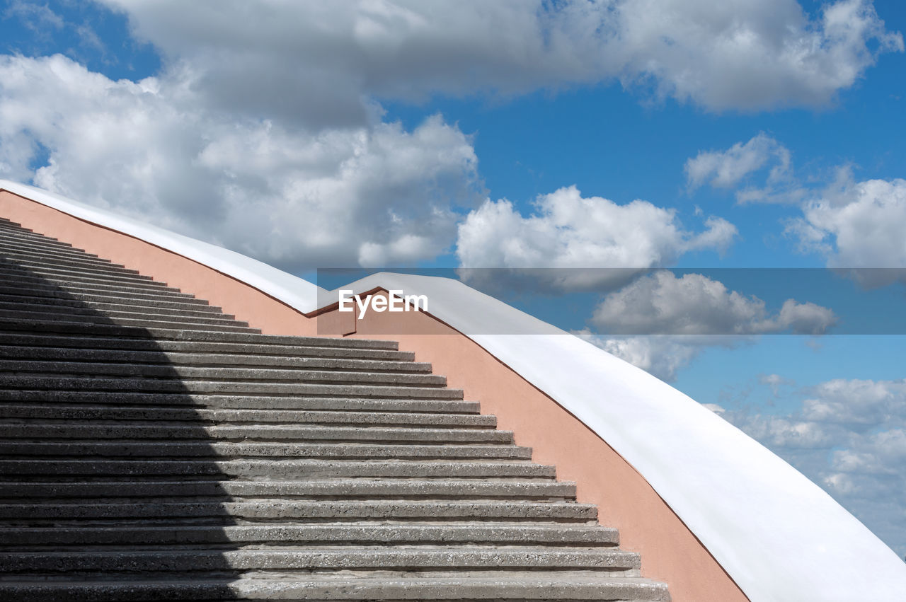 LOW ANGLE VIEW OF STAIRCASE ON BUILDING AGAINST SKY