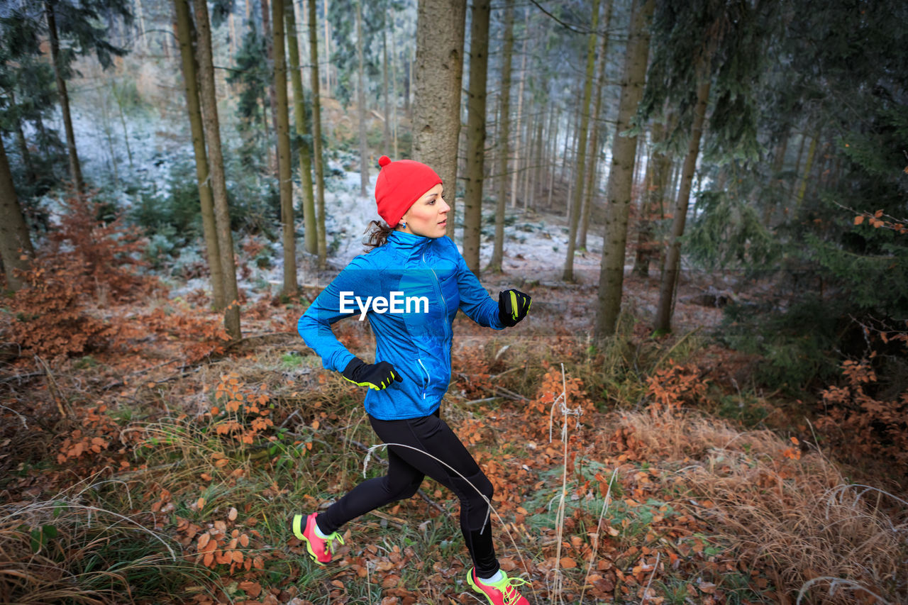 Woman running in forest