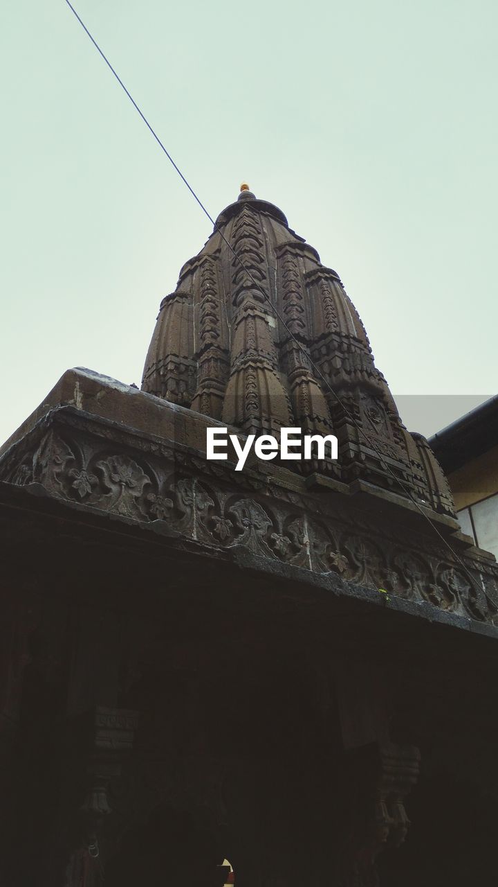 LOW ANGLE VIEW OF TEMPLE AGAINST CLEAR SKY