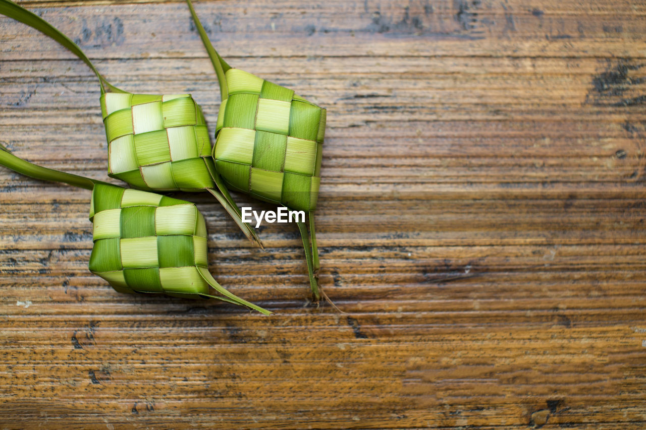 High angle view of green boxes on wooden table