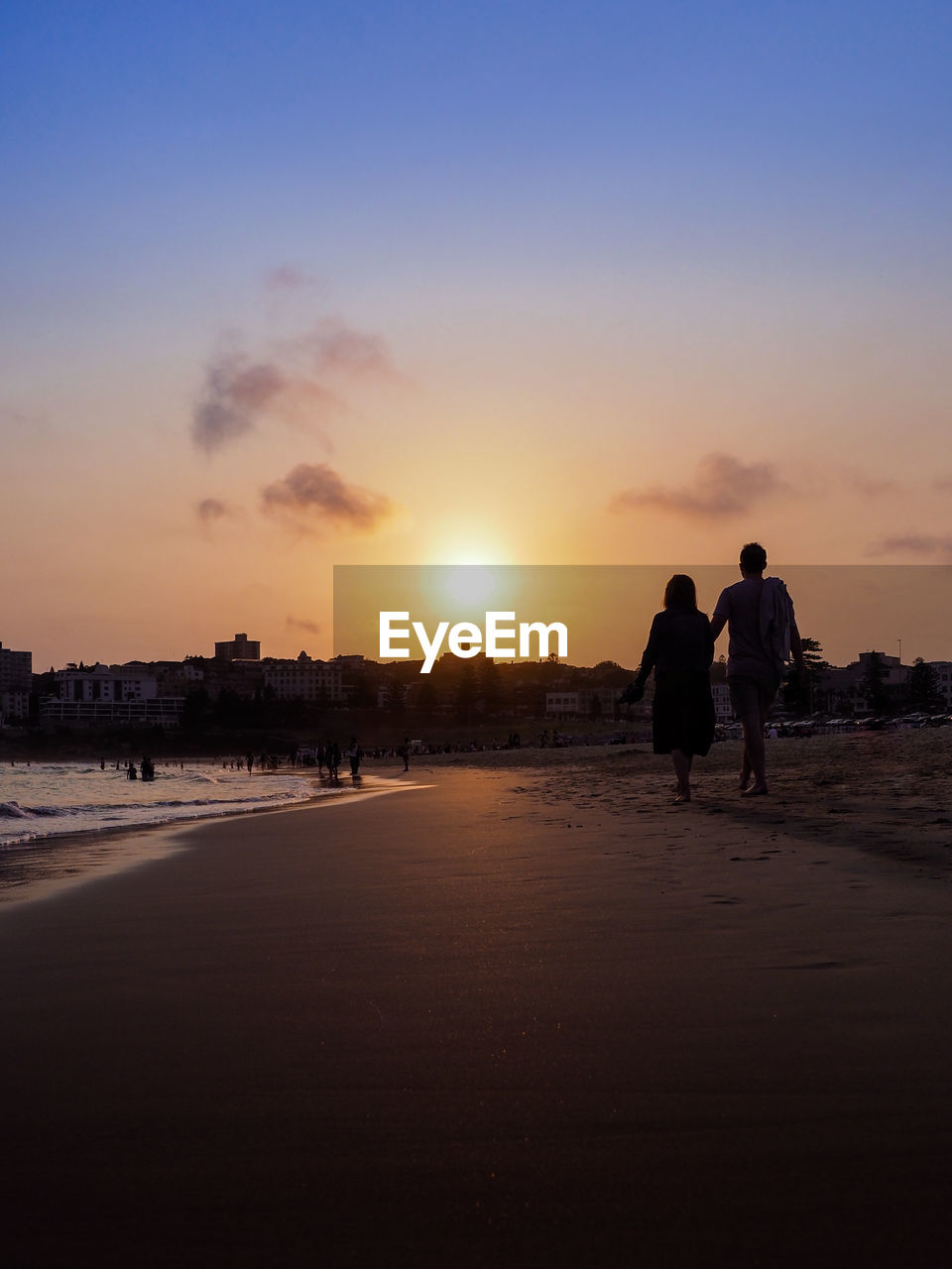 PEOPLE ON BEACH DURING SUNSET