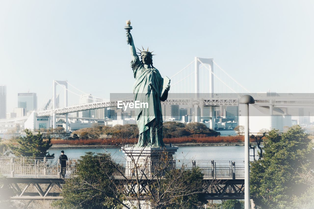 Odaiba statue of liberty against sky in city