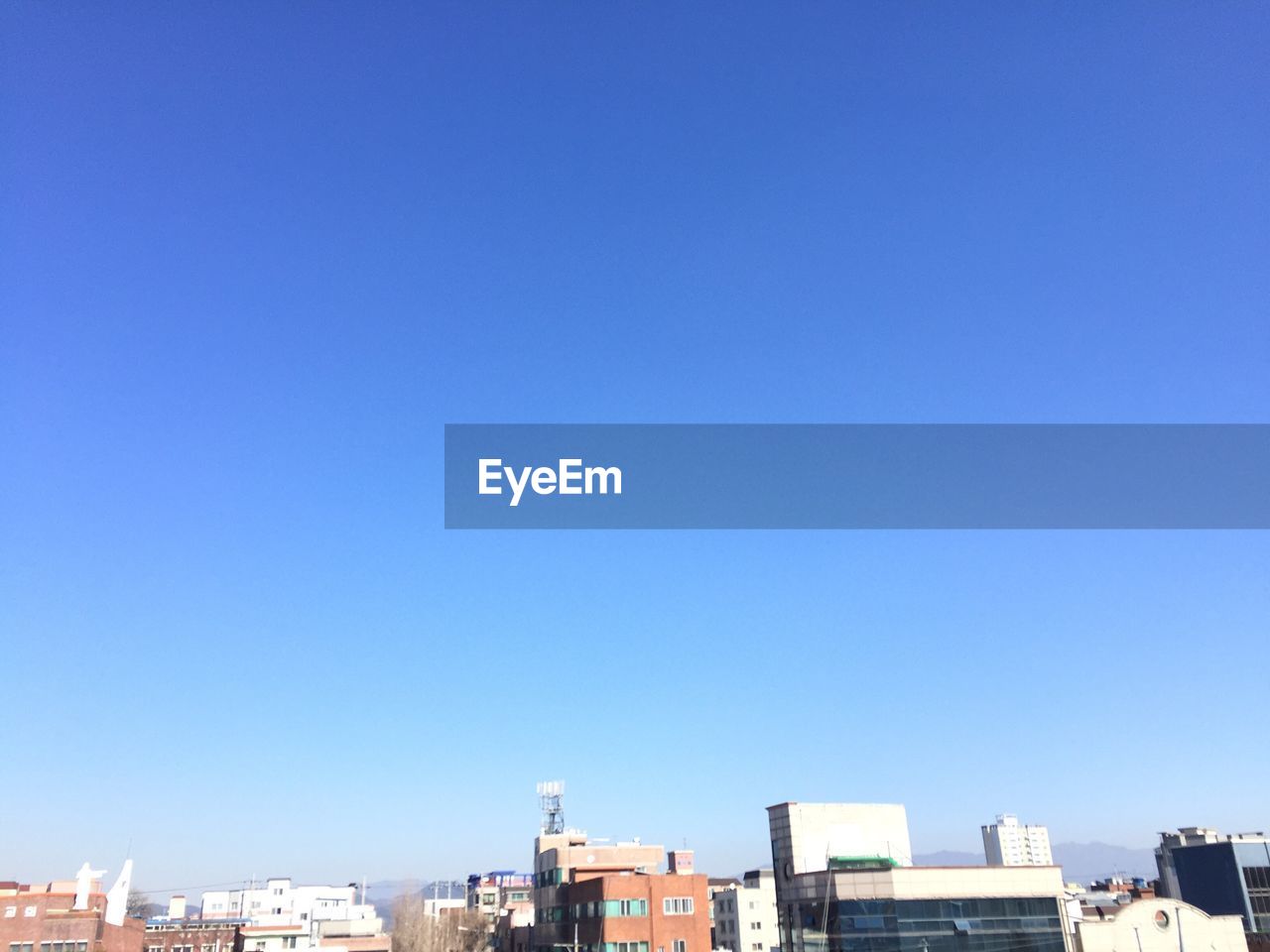 BUILDINGS AGAINST CLEAR BLUE SKY