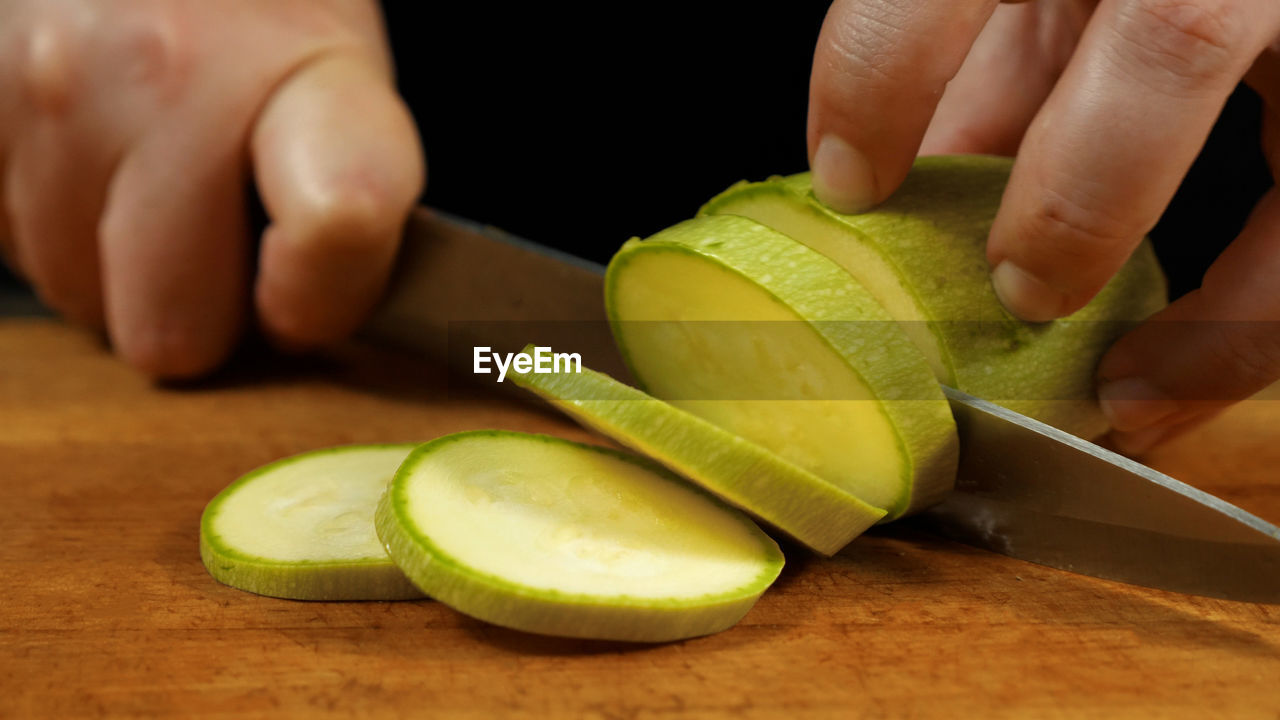 Cropped hand of man holding fruit