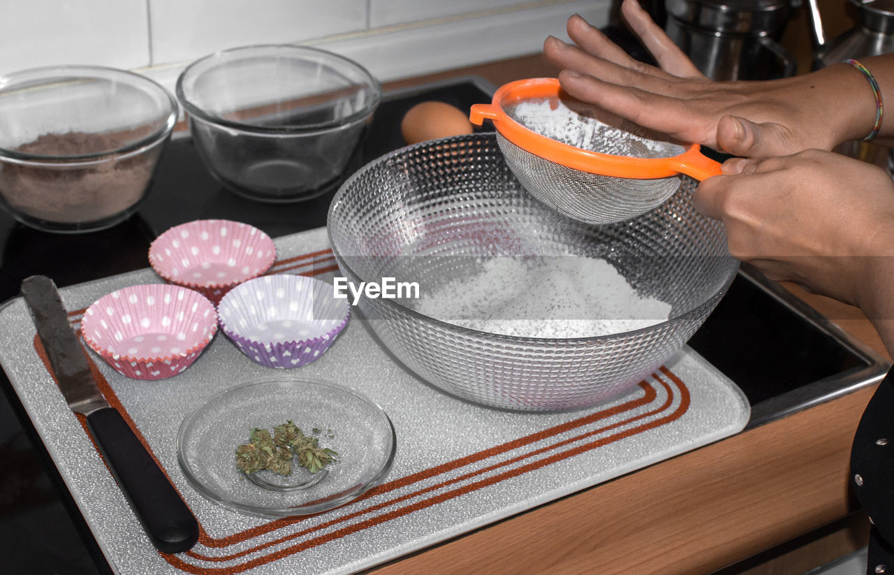 HIGH ANGLE VIEW OF MAN PREPARING FOOD