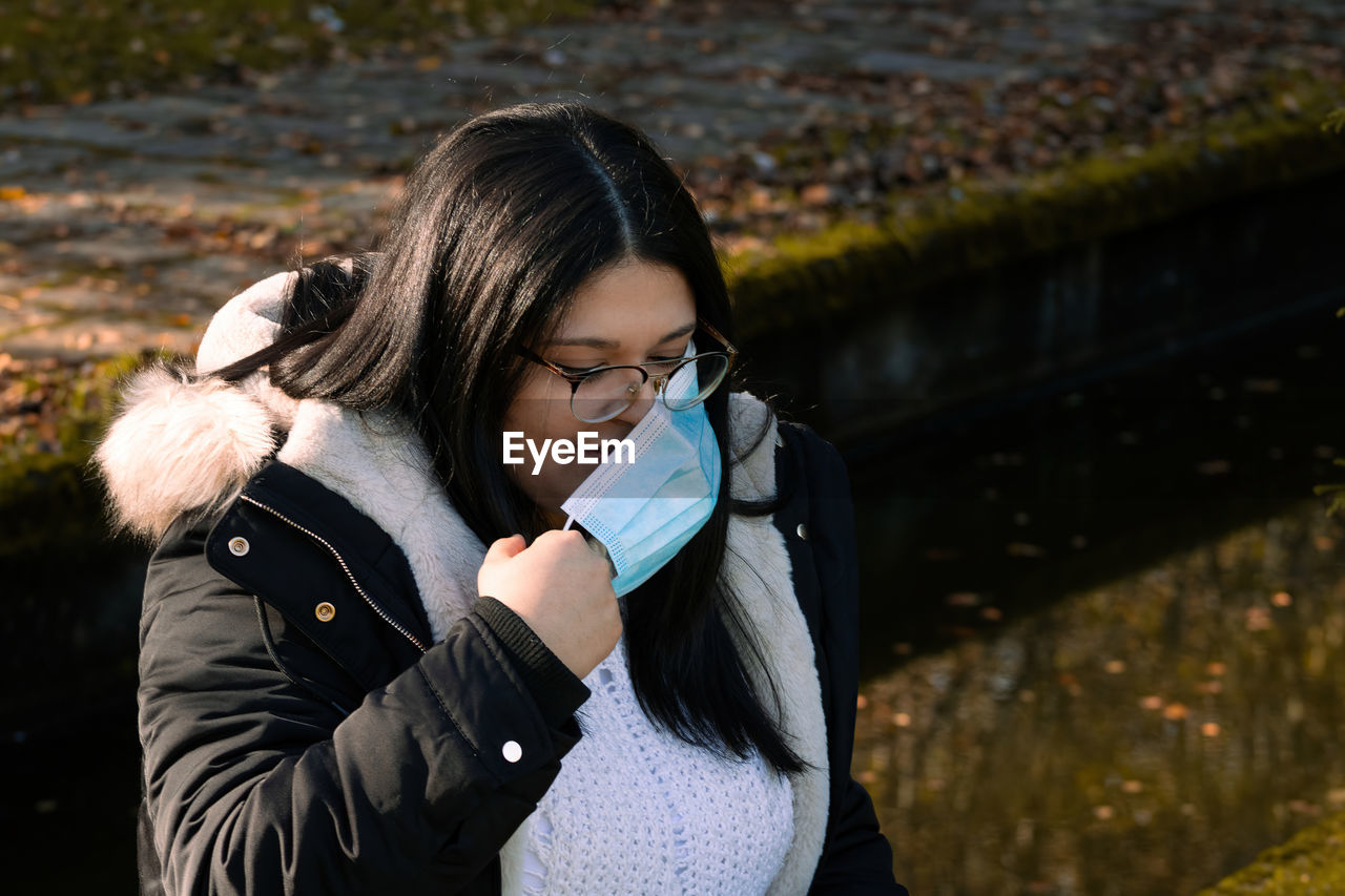 Woman with surgical mask in the park