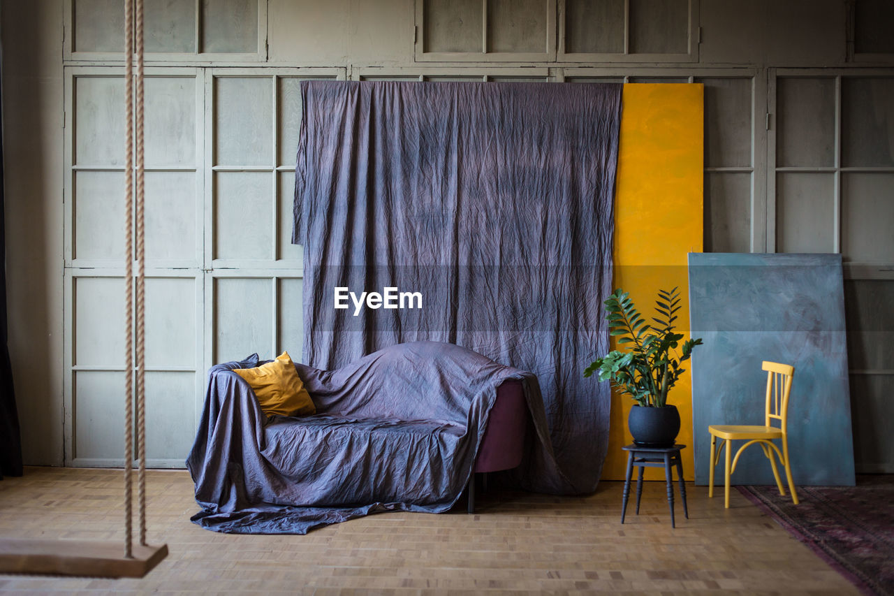 Empty sofa and table against wall at home