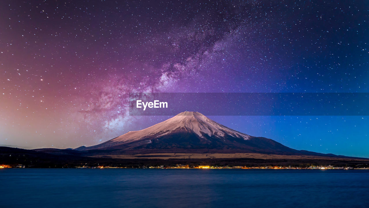 Fuji mountain at yamanachi in japan,  at night with milky way galaxy and kawaguchiko lake, japan.