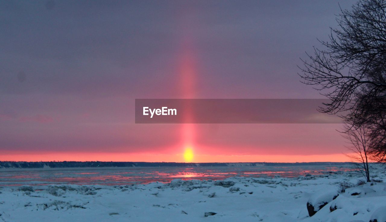 Scenic view of rainbow against sky during winter