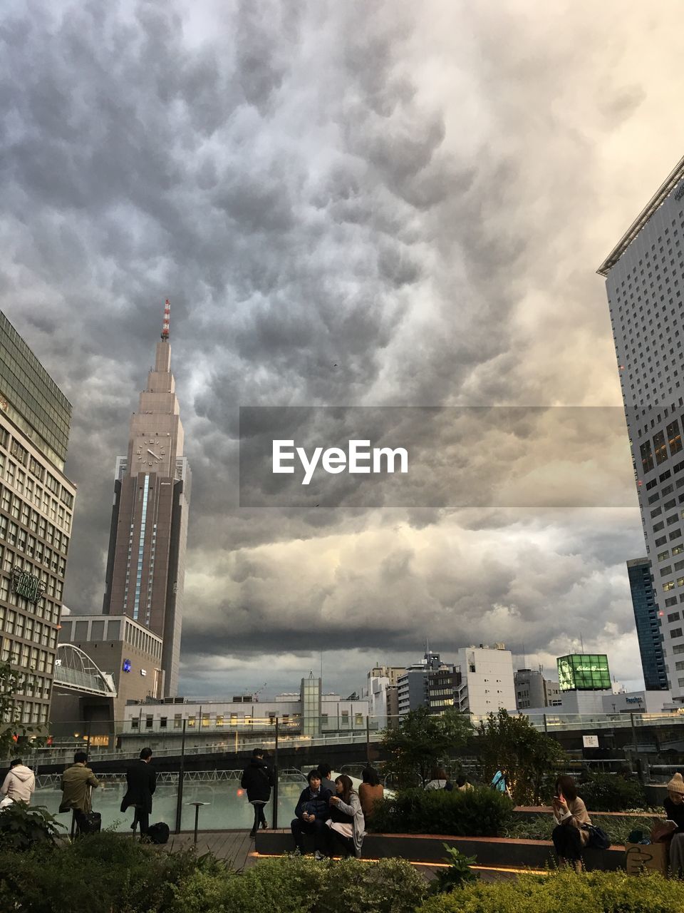 VIEW OF SKYSCRAPERS AGAINST CLOUDY SKY