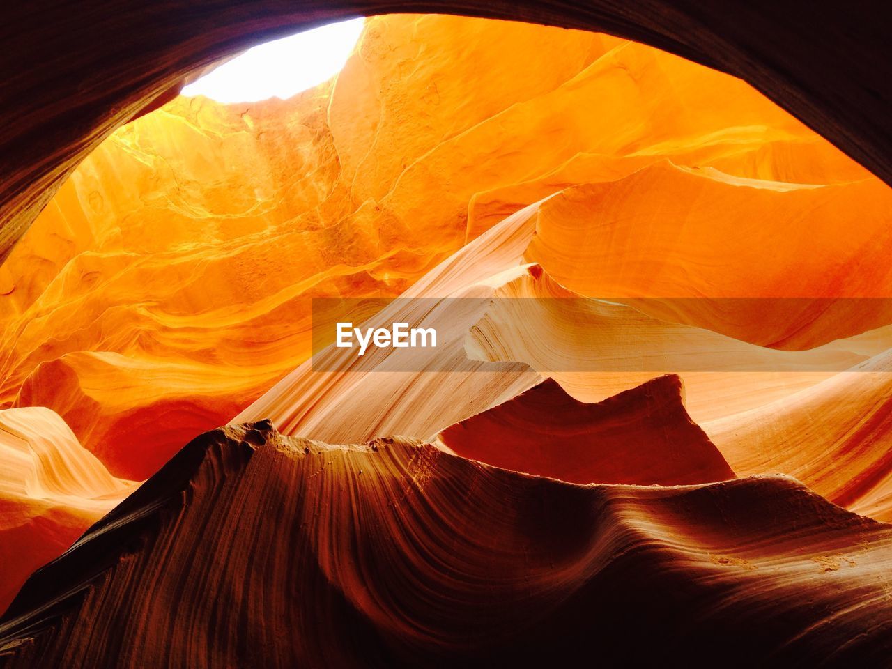 LOW ANGLE VIEW OF ROCK FORMATION IN SUNLIGHT