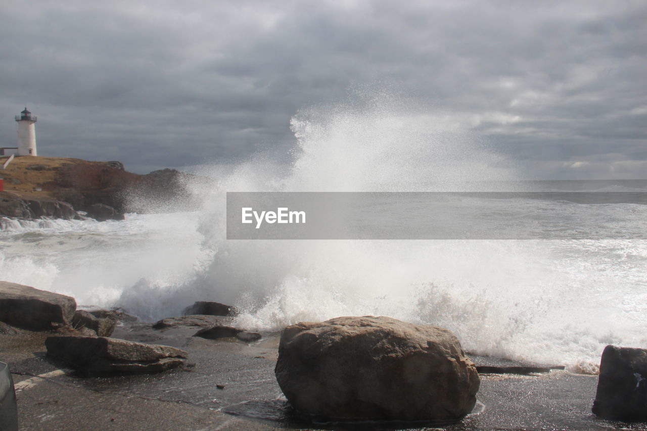 water, sea, rock, shore, ocean, motion, coast, wave, breaking, nature, beauty in nature, body of water, power in nature, wind wave, beach, land, sky, cloud, no people, blowhole, hitting, outdoors, scenics - nature, breakwater, sports, day, splashing