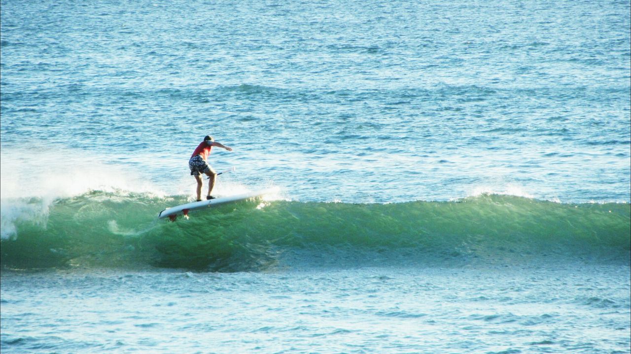 Full length of man surfing