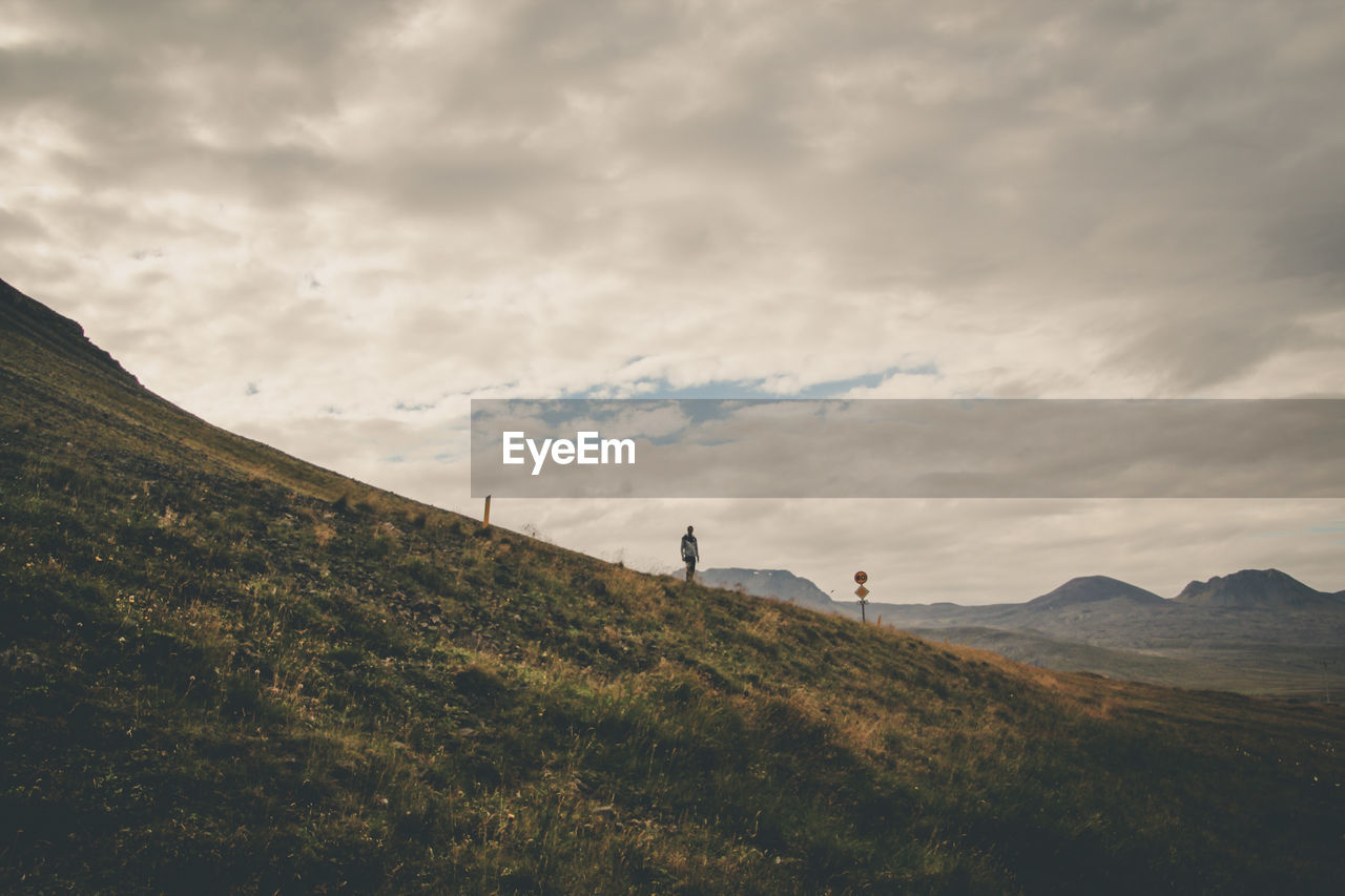 Scenic view of mountains against cloudy sky