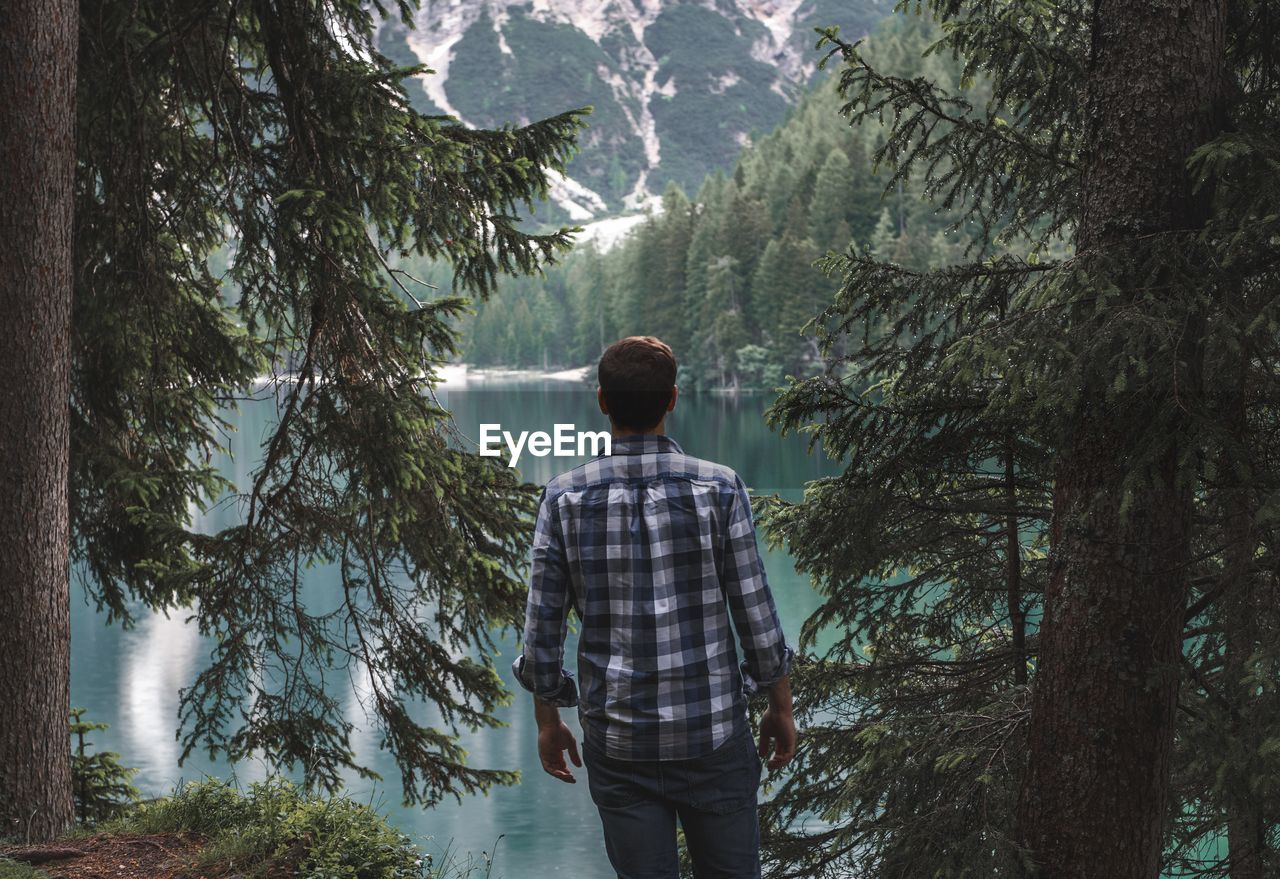 Rear view of man looking at lake