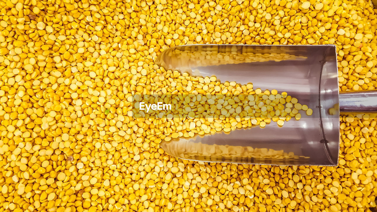 CLOSE-UP OF YELLOW AND COFFEE BEANS