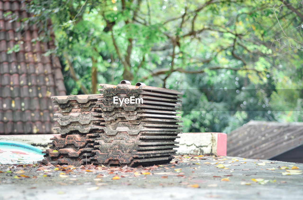 Close-up of stone stack on table against trees