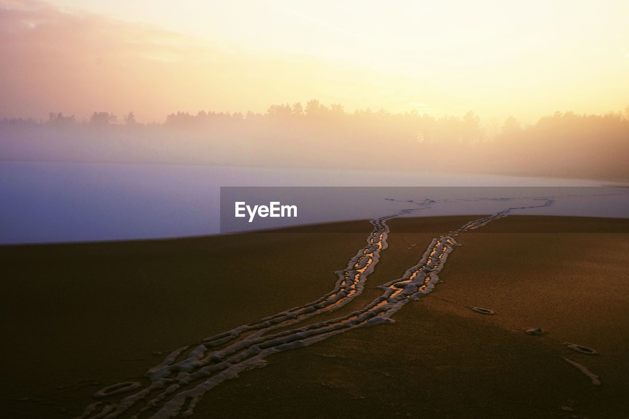 Scenic view of land against sky during sunset