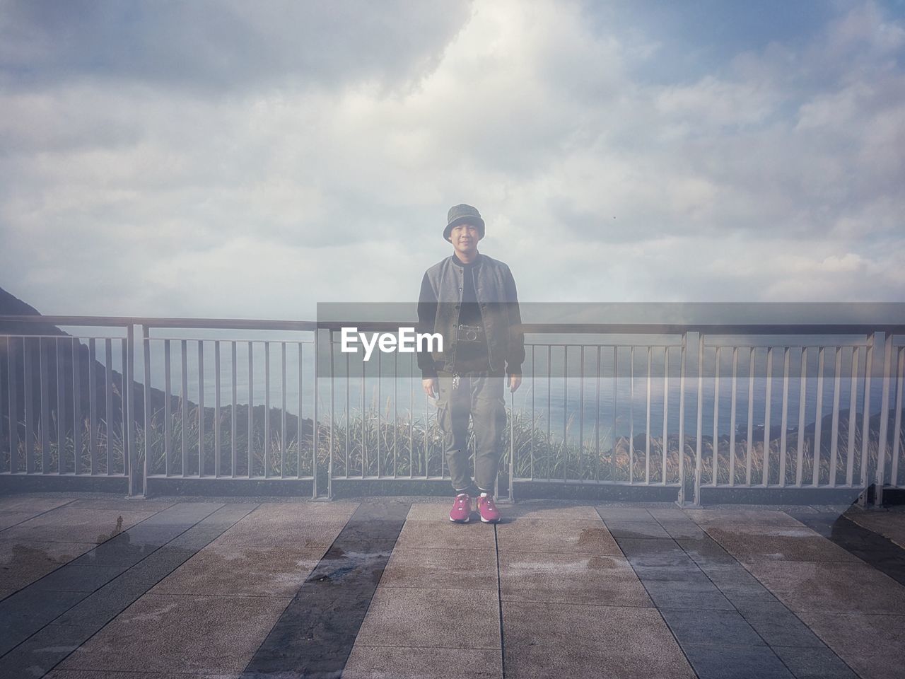 Double exposure of man standing at observation point