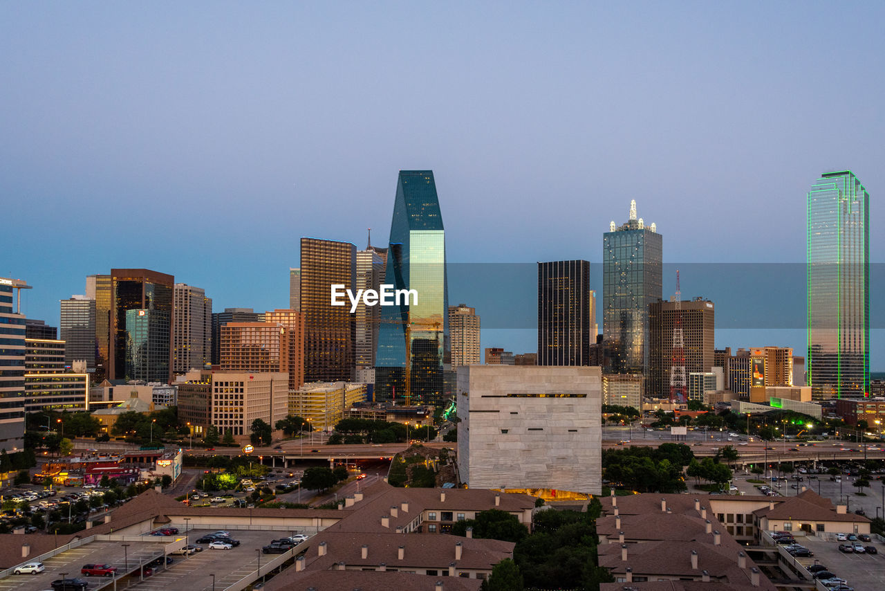 Modern buildings in city against clear sky