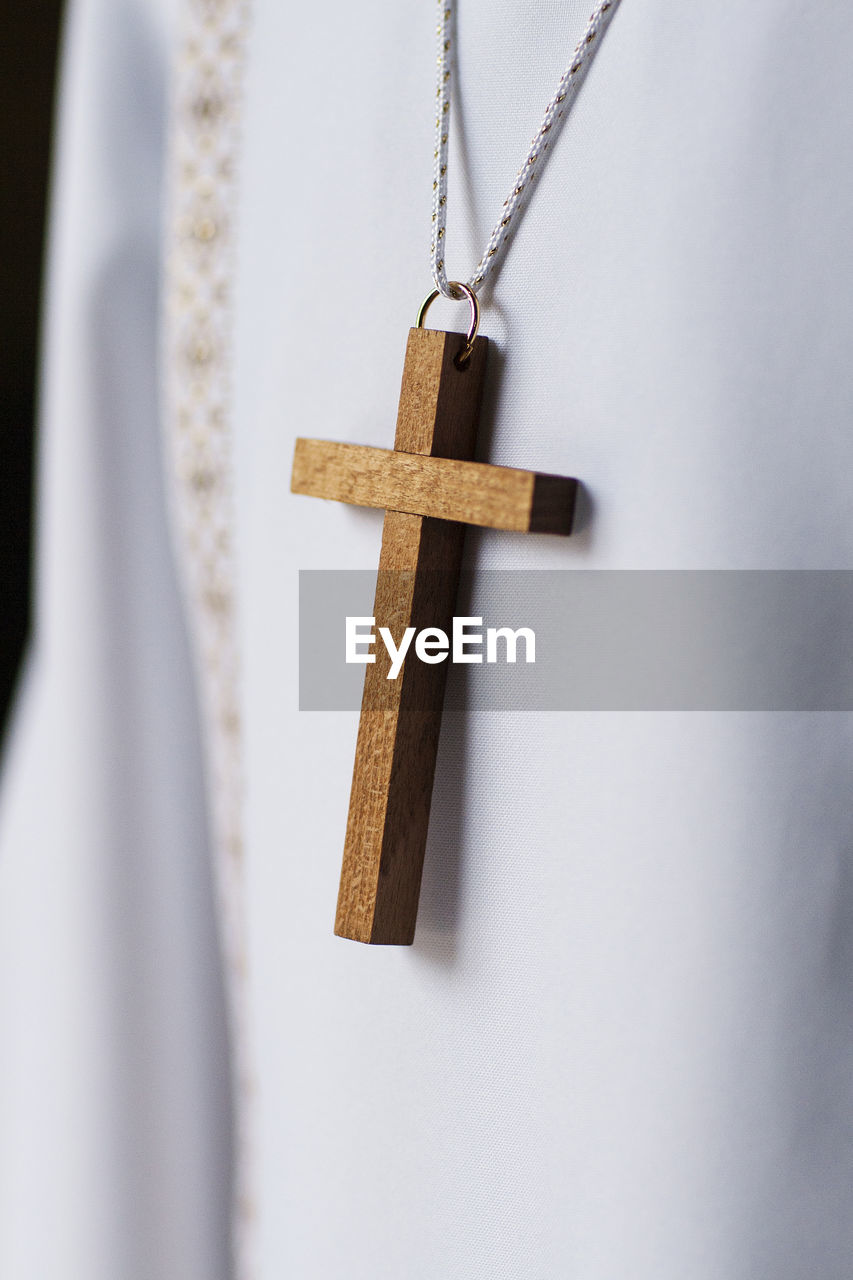 Close-up of religious cross hanging on necklace