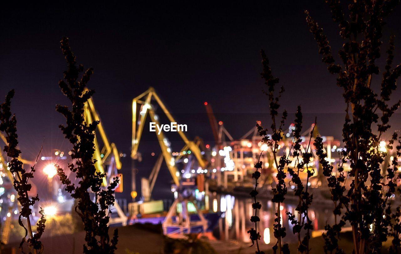 Blurred shot of lake with cranes in distance