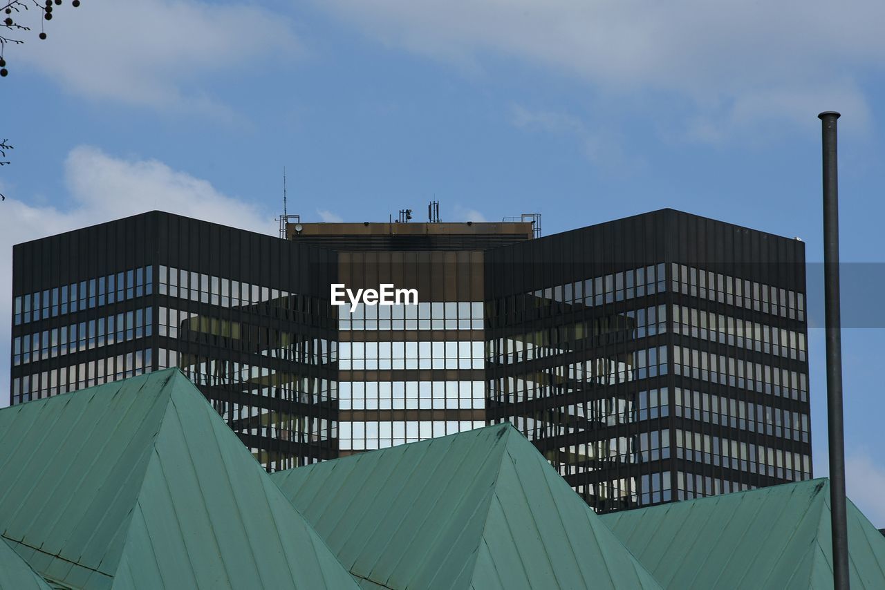 Low angle view of building against cloudy sky