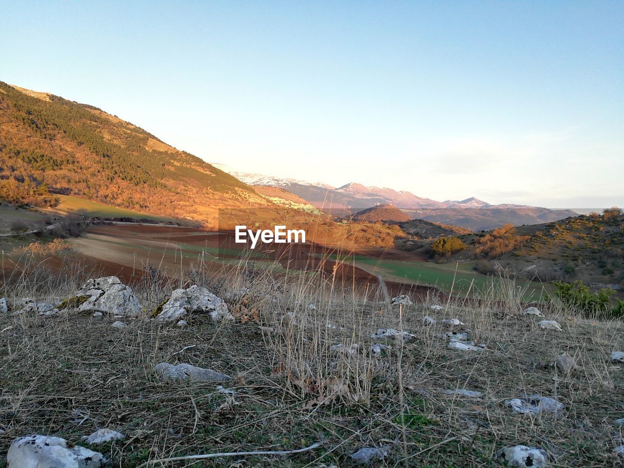 SCENIC VIEW OF LANDSCAPE BY MOUNTAINS AGAINST SKY