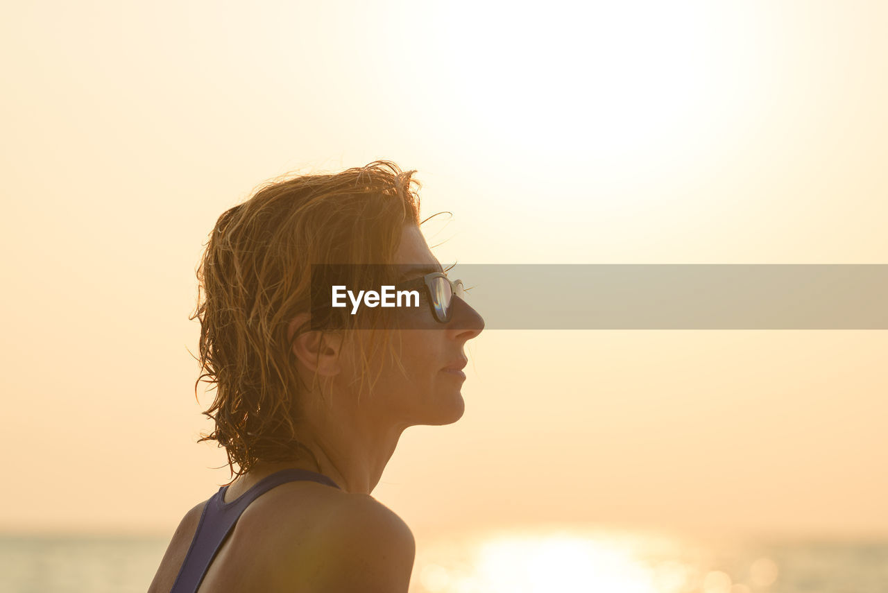 Portrait of woman looking at sunset