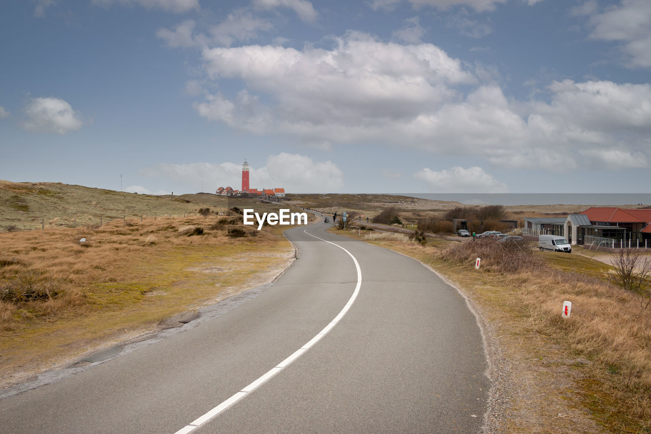Country road and lighthouse called eierland on the wadden island of texel, the netherlands