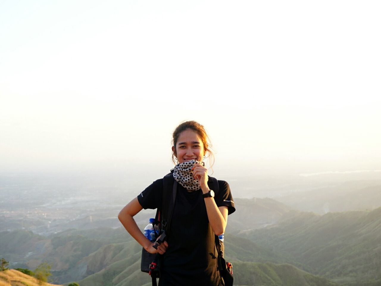 Portrait of happy hiker standing against clear sky during sunset