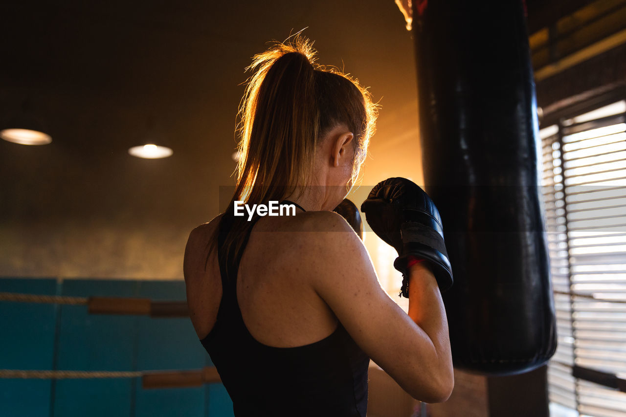 rear view of woman looking away in gym