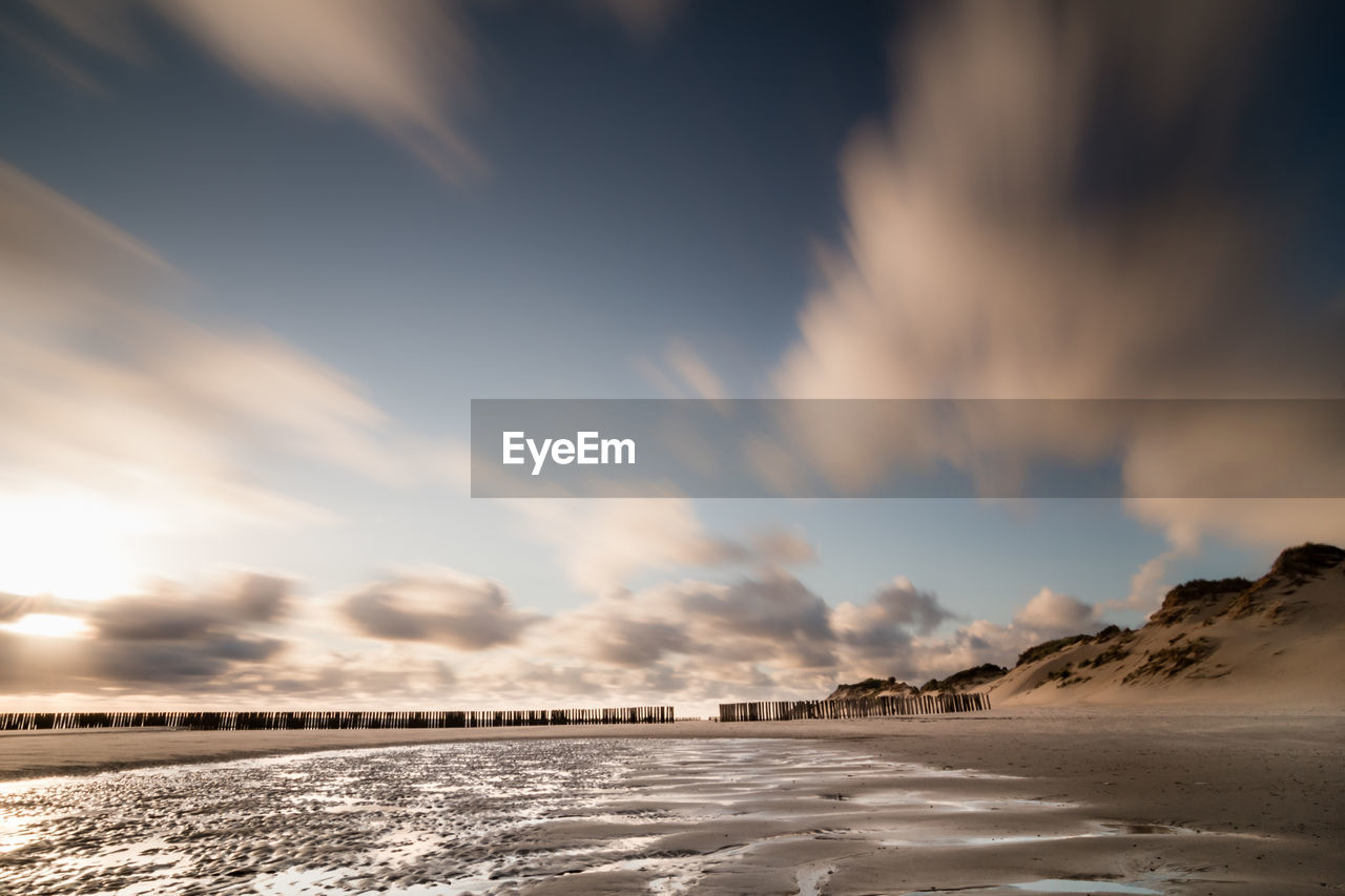 Scenic view of beach against sky during sunset