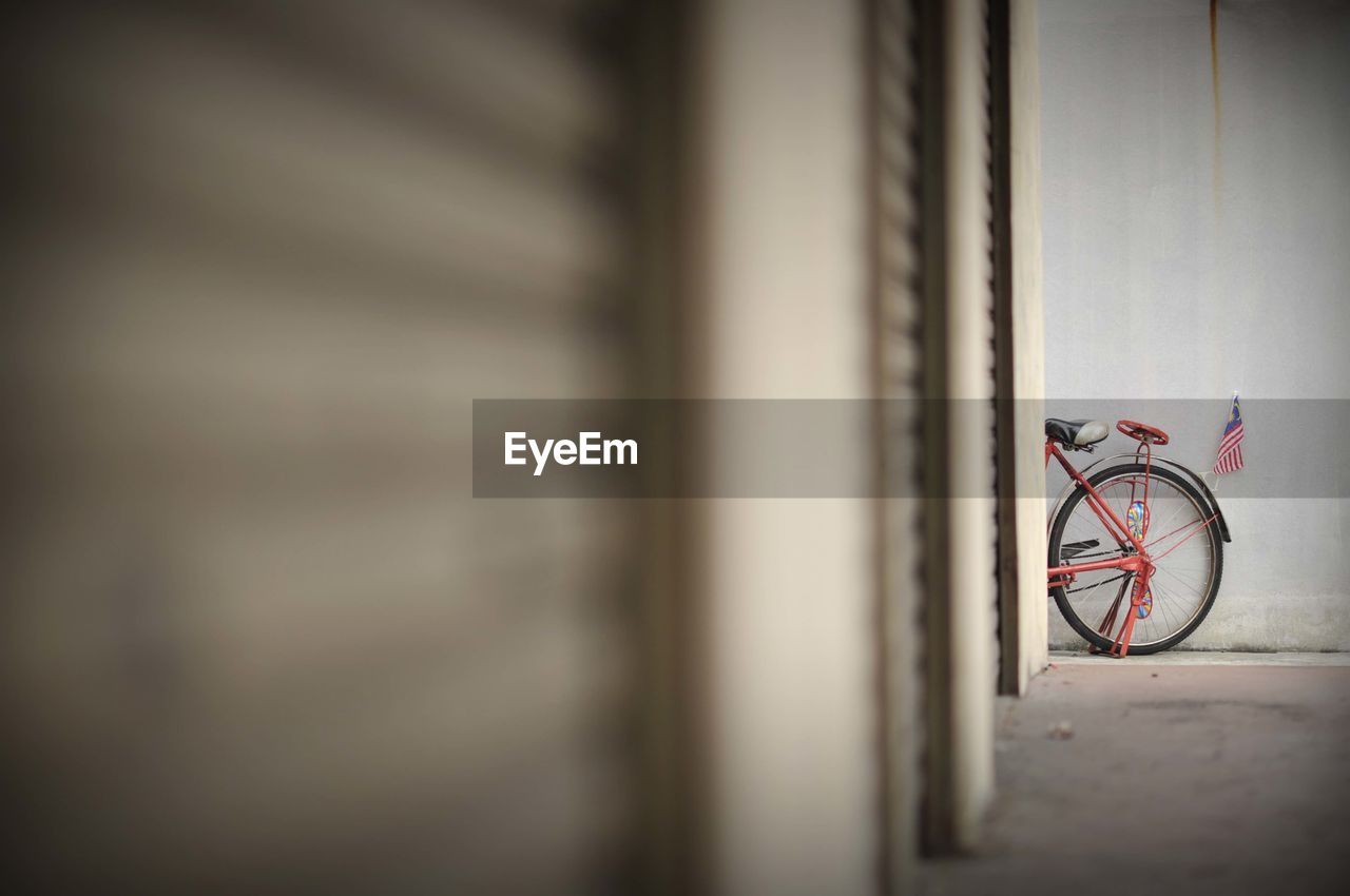 Bicycle leaning on wall of building