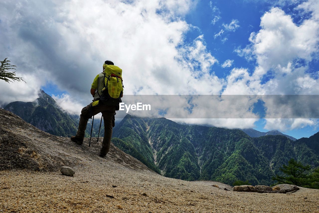 Rear view of man hiking on mountains