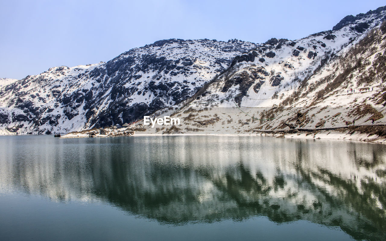 Scenic view of snowcapped mountains against clear sky