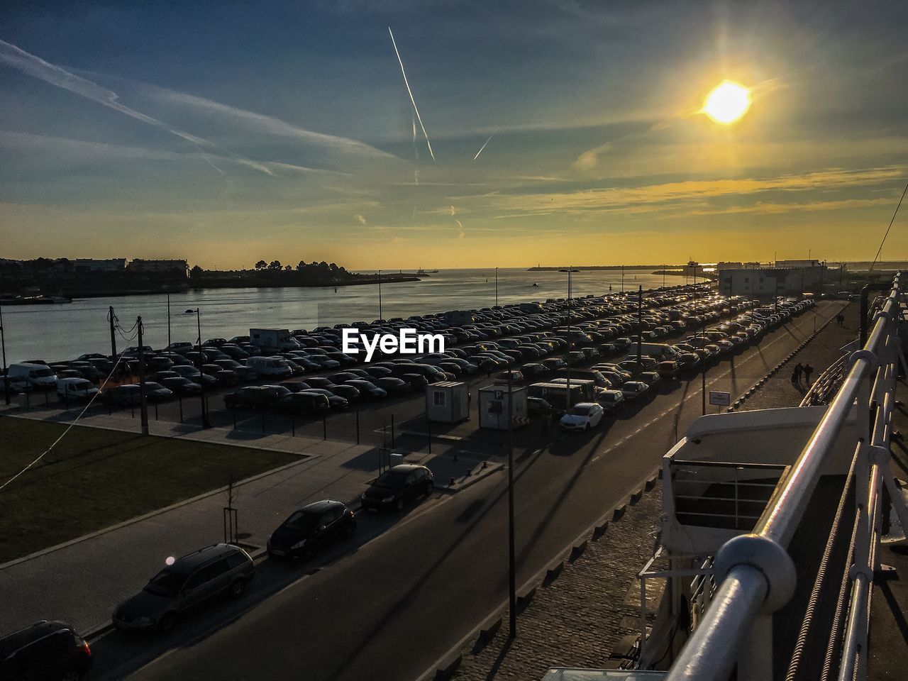 HIGH ANGLE VIEW OF COMMERCIAL DOCK AGAINST SKY DURING SUNSET