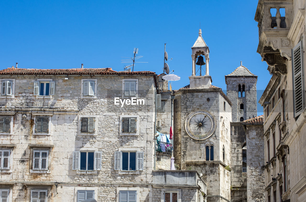 Low angle view of historic building against clear blue sky