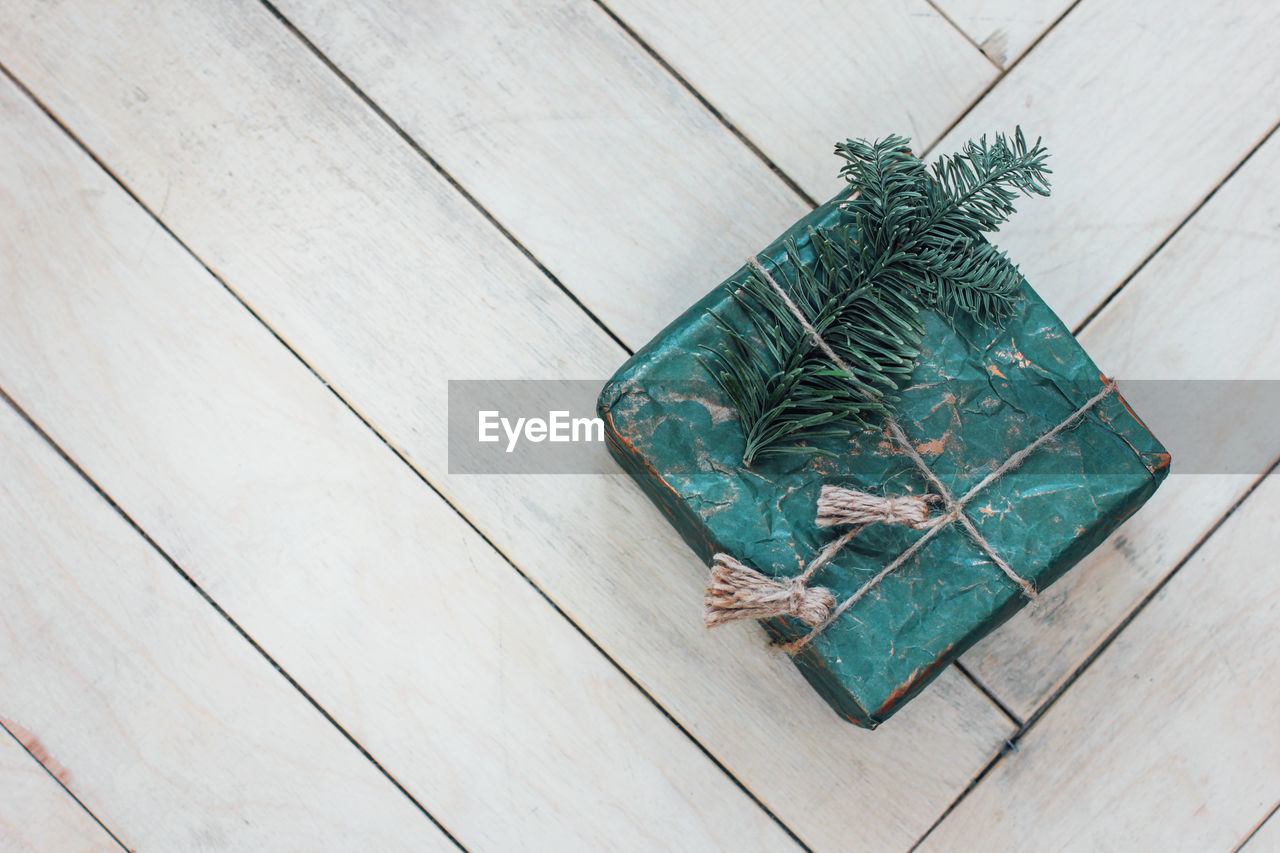 High angle view of christmas gift on hardwood floor